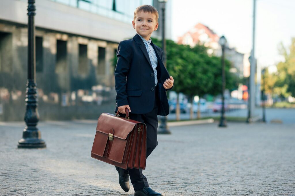 Future businessman in formal costume with briefcase