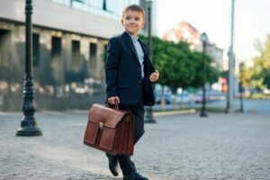 Future businessman in formal costume with briefcase